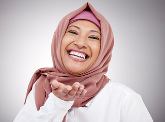 Image showing Muslim woman, portrait and blowing a kiss in studio with happiness, kindness or positive attitude. Hijab, islam and fashion of a mature person on grey background for beauty, cosmetics or flirting