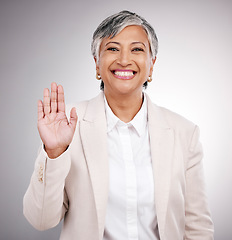 Image showing Portrait, business and a studio wave from a woman for hello, welcome or a professional pledge. Happy, mature and a corporate manager or person with a hand for greeting or thank you on a backdrop