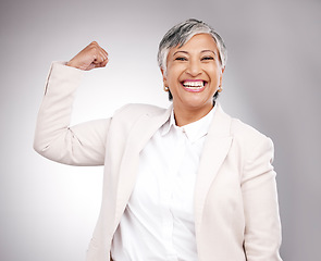 Image showing Strong, smile and portrait of businesswoman in a studio with strength or confidence gesture. Happy, excited and mature female model from Mexico flexing arm muscles for empowerment by gray background.