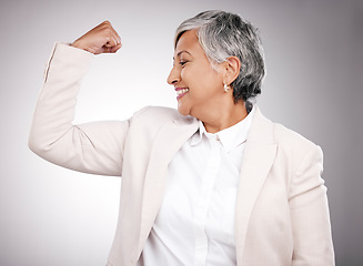 Image showing Strong, smile and mature businesswoman in a studio with strength, feminism or confidence gesture. Happy, empowerment and female model from Mexico flexing her arm muscles for emoji by gray background.