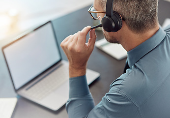 Image showing Businessman, laptop mockup and call center with headphones in customer service or telemarketing at office. Man, consultant or agent in online advice, help or contact us on computer at the workplace