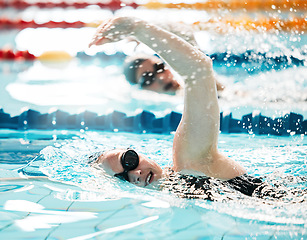 Image showing Sports, water splash or people training in swimming pool in a race competition, exercise or cardio workout. Swimmer, fast or athletes with energy or speed in fitness performance or practice challenge