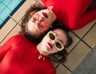 Image showing Women, sunglasses and urban fashion at a pool with gen z, hipster and style of girl friends with top view. Red clothing, cool and trendy glasses with young people on a floor with student model