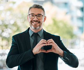 Image showing Portrait, business man and heart hands outdoor for care, kindness or love emoji for peace. Happy mature executive entrepreneur with finger shape for thank you, trust and like icon for support in city