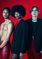 Image showing Fashion, portrait and a group of people on a red background for art, punk and creative aesthetic. Retro, rock and a black woman with men on a studio backdrop for vintage clothes and trendy style