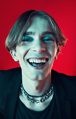 Image showing Fashion, face and funny gay man in makeup at studio isolated on a red background. Cosmetics, lgbtq style and portrait of model laughing in cool clothes, aesthetic and happy queer person in Australia