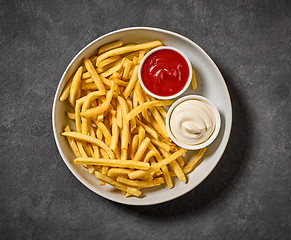 Image showing plate of french fries with ketchup and mayonnaise