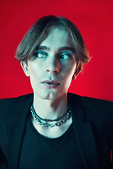 Image showing Fashion, thinking and gay man in makeup at studio isolated on a red background. Cosmetics, lgbtq style and male model in cool clothes, aesthetic and serious idea for queer or non binary