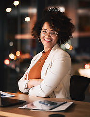 Image showing Night, portrait and a black woman with arms crossed at work for business pride or a deadline. Desk, happy and an African employee with confidence during overtime and late shift in the office