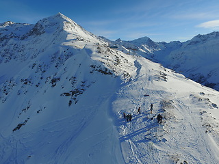 Image showing Mountain, snow and hiking in the Swiss Alps for travel, holiday or vacation with a view of nature. Environment, landscape or freedom with people at a ski resort in a remote location in Europe