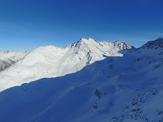 Image showing Mountain, snow and sky on the Swiss Alps for travel, holiday or vacation with a view of nature. Environment, landscape and adventure in a remote location in cold weather season of winter in Europe