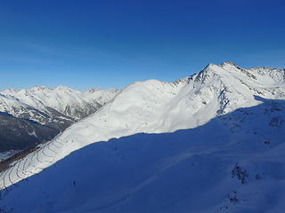 Image showing Mountain, snow and the Swiss Alps in winter for adventure, holiday or vacation with a view of nature. Environment, landscape and travel in a remote location during the cold weather season in Europe