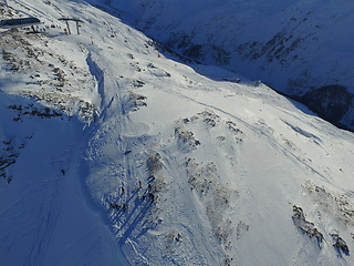 Image showing Mountain, snow and the Swiss Alps in winter for adventure, holiday or vacation in nature from above. Environment, landscape and travel at a ski resort lift in the cold weather season in Switzerland