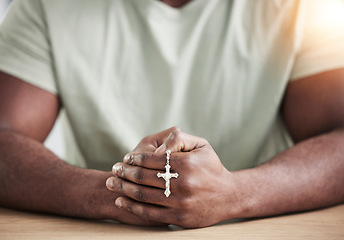 Image showing Crucifix cross, man hands and prayer beads in home with faith, christian praise and religion. Praying, necklace and worship in house with hope, gratitude and spiritual guide for support and healing