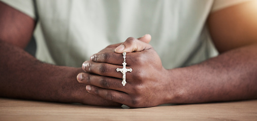 Image showing Rosary cross, person hands and prayer beads in home with faith, christian praise and religion. Praying, necklace and worship in house with hope, gratitude and spiritual guide for support and healing