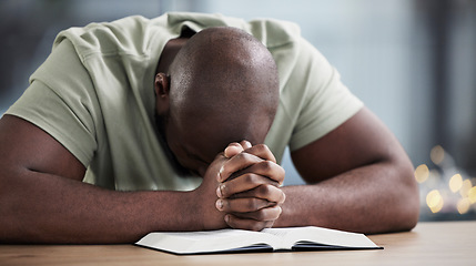 Image showing Bible, praying and man with book and religion study at home for worship and spiritual support. Faith, christian knowledge and person with gratitude, scripture education and hope for guidance in house