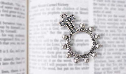 Image showing Rosary, open book or bible study for worship, religion or mindfulness with holy spiritual scripture. Christian literature, background or history education or knowkedge guide on God or Jesus Christ