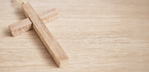 Image showing Background, religion and space of wood cross on table for worship to God, prayer and resurrection of Jesus Christ. Christian faith, mockup banner and crucifix sign for holy spirit, heaven and trust