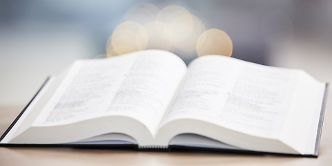 Image showing Religion, christian and bible book on a table for praying, spiritual faith or holy worship to God. Closeup of open scripture for studying, reading prayer or story of Jesus Christ hope or gospel