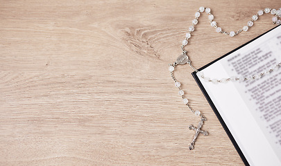 Image showing Bible, cross and religion, Christian and God with worship, studying scripture and rosary beads. Jesus Christ, prayer and spiritual, holy book and praise with top view, gospel and mockup space