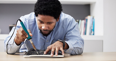 Image showing Black man, soldering iron and fixing circuit board, computer hardware and maintenance with electronics upgrade. Tools, motherboard and CPU, engineering and electric repair with technology in office