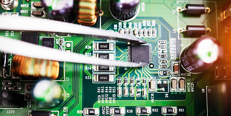 Image showing Motherboard, microchip closeup and engineering tweezer with electric maintenance of circuit board. Developer, IT and dashboard for electrical hardware update and technician tools for technology