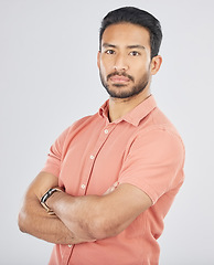 Image showing Portrait, confident and arms crossed with a serious asian man in studio on gray background. Fashion, mindset and pride with a young model posing in a pink shirt for trendy clothes style in Japan