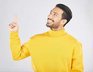 Image showing Announcement, pointing and thinking man with promotion, deal and logo isolated in a studio white background with smile. Choice, ambassador and happy person showing advertising, news or notification