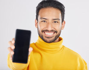 Image showing Portrait, phone screen and mockup by happy man in studio with space for social media or promo on white background. Smartphone, display and face of male model with app, review or coming soon sign up