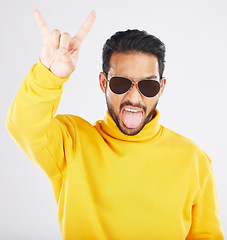 Image showing Man, horns and hand with sunglasses, studio portrait and rock icon for gesture, clothes and white background. Young guy, model and devil fingers for attitude, fashion and sign with emoji for culture