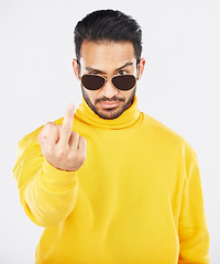 Image showing Man, middle finger and sunglasses in studio portrait with anger, rude and frustrated by white background. Indian fashion model, guy and emoji for sign language, vote or opinion with hand for conflict