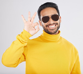 Image showing Fashion, happy and man with okay sign on a white background for approval, agreement and yes. Emoji, sunglasses and face of person smile in studio with perfect, good review and support hand gesture