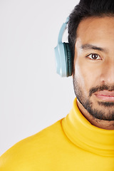 Image showing Half portrait, man and headphones on a white background for a podcast, music or streaming radio. Serious, face and an Asian person listening to sound, audio or a track isolated on a studio backdrop