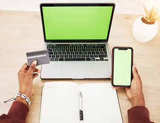 Image showing Woman, hands and laptop with phone green screen mockup and credit card in online shopping or banking at office. Female person with debit on computer or smartphone app display in ecommerce or fintech