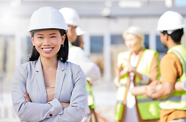 Image showing Construction worker, architecture and Asian woman on engineering site with team or designers for property renovation. Portrait, professional and arms crossed of project leader for building inspection