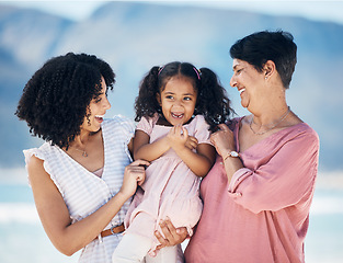 Image showing Happy family, hug and girl with mother and grandmother at the beach with freedom, fun and bond in nature. Love, smile and child with mom and grandma at sea for travel, vacation or ocean trip in Miami