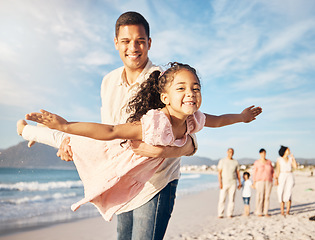 Image showing Smile, beach and father doing airplane with girl having fun on family vacation or holiday. Happy, travel and young dad playing and bonding with child by ocean on adventure or weekend trip together.