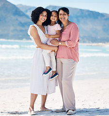 Image showing Beach, portrait and happy family hug in nature with freedom, fun and bonding at the ocean. Love, smile and girl child with mother, grandmother and embrace at sea for summer vacation, trip or holiday