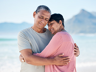 Image showing Mature couple, love and hug outdoor at beach with a smile, care and happiness together in nature. A happy man and woman for healthy marriage, commitment and freedom on travel, holiday or vacation