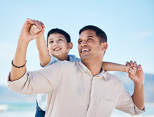 Image showing Happy, beach and father doing airplane with child having fun on family vacation or holiday. Happiness, smile and young dad playing with his boy kid by the ocean on adventure or weekend trip together.