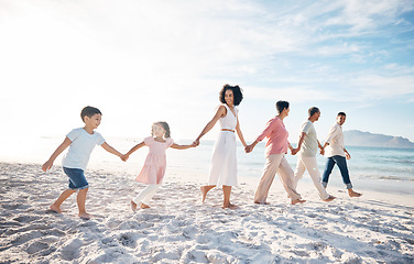 Image showing Family, holding hands and outdoor at beach with love, care and happiness together in nature. Men and women or parents, grandparents and children walk, travel and playing on fun journey or holiday