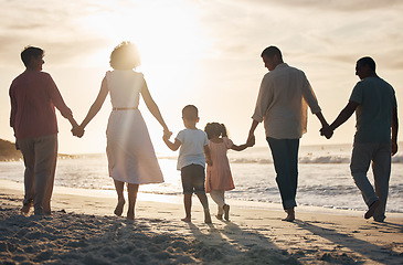 Image showing Beach, sunset and back of family holding hands in nature for travel, bond and fun together. Rear view, love and children with parents, grandparents and walking at sunrise on holiday adventure