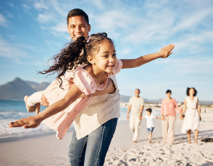 Image showing Happy, beach and dad doing airplane with kid having fun on family vacation, adventure or holiday. Travel, smile and young father playing with his girl child by the ocean on a weekend trip together.