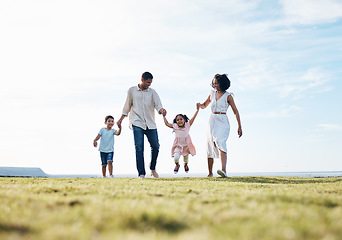 Image showing Holding hands, family and outdoor at a park with love, care and happiness together in nature. Young man and woman or parents with children on walk, sky and playing on fun journey or travel holiday