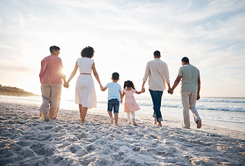 Image showing Walking, holding hands and back of big family at the beach for travel, vacation and adventure in nature. Love, freedom and rear view of children with parents and grandparent at sea for ocean journey