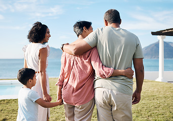 Image showing Back, summer and vacation by the sea with family outdoor together looking at a view of nature. Grandparents, mother and happy son by the ocean for love, holiday freedom or weekend getaway and travel