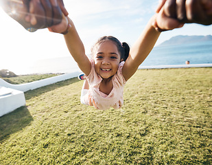 Image showing Girl, spin and outdoor portrait in pov, holding hands or happy for game with parent, holiday or backyard. Female child, smile and swing in air, fast or excited for play on vacation in summer sunshine