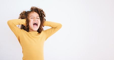 Image showing Shouting, loud and mockup with a girl child in studio on a white background covering her ears. Children, sound and audio with a young kid screaming or yelling on empty space for ADHD or autism