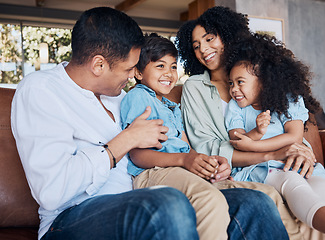 Image showing Happy, tickle and relax with family on sofa for smile, bonding and peace on holiday. Love, care and happiness with parents and children in living room at home for vacation, cuddle or embrace together