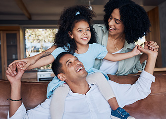 Image showing Family, parents and child, happiness and bonding with girl on dad shoulders at home, love and trust with care. Smile, piggyback and mother, father and kid relax on couch, positivity and childhood